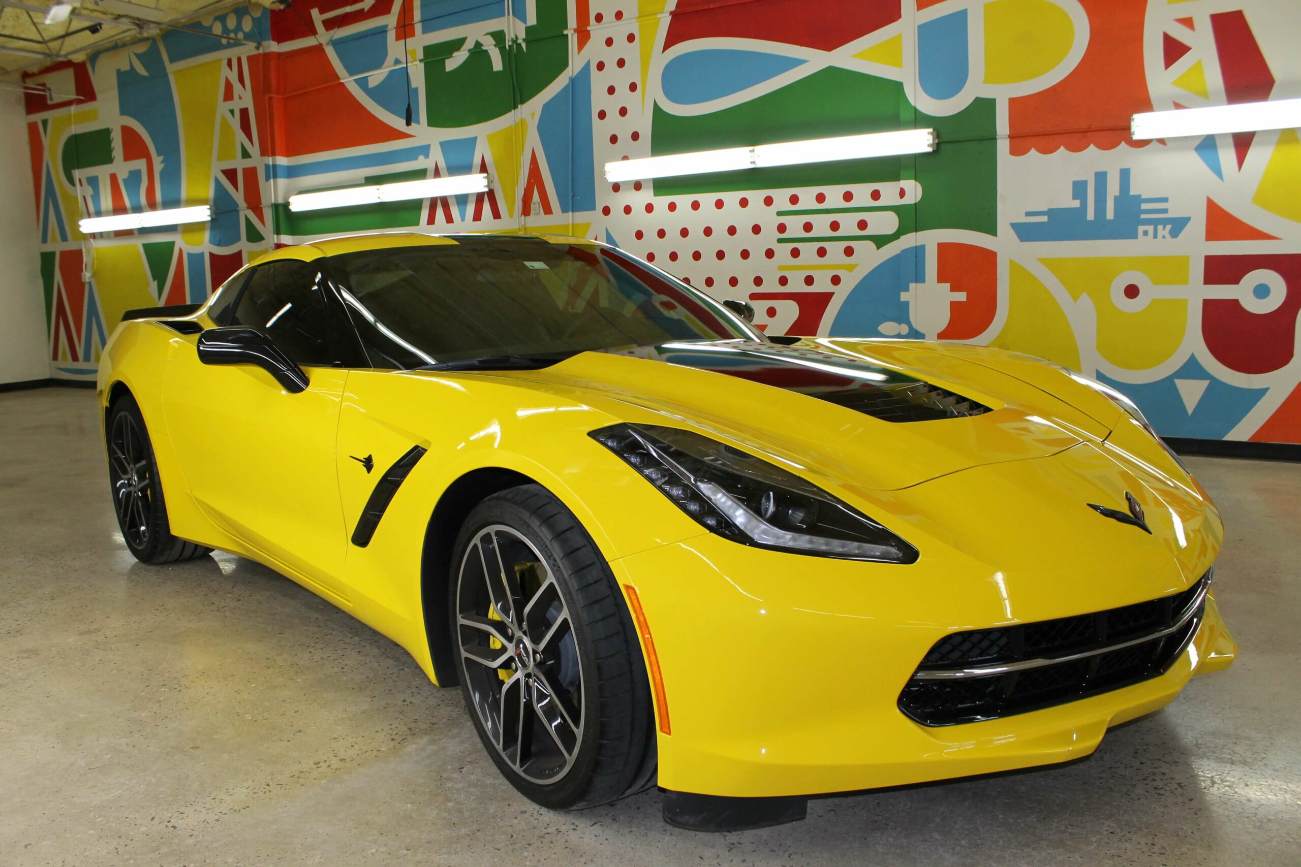 Yellow vinyl wrapped luxury car in indoors